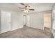 Spacious bedroom with ceiling fan and access to bathroom at 676 Tarkington S Rd, Stone Mountain, GA 30088