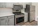 Modern kitchen with stainless steel appliances and gray cabinets at 676 Tarkington S Rd, Stone Mountain, GA 30088