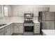 Modern kitchen with stainless steel appliances and gray cabinets at 676 Tarkington S Rd, Stone Mountain, GA 30088