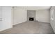 Living room with gray carpeting and a stone fireplace at 676 Tarkington S Rd, Stone Mountain, GA 30088