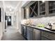 Butlers pantry with gray cabinetry, wine fridge, and quartz countertop at 3182 Shumard Way, Marietta, GA 30064