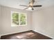 Well-lit bedroom with dark hardwood floors and a large window at 4902 Cedar Se Ct, Conyers, GA 30094