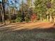 Spacious backyard with mature trees and fall leaves at 5423 Pine Valley Dr, Union City, GA 30291