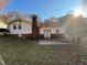 House with brick chimney, patio, and wooded backyard at 5423 Pine Valley Dr, Union City, GA 30291