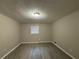 Spacious bedroom with light grey walls and wood-look flooring at 5423 Pine Valley Dr, Union City, GA 30291