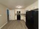 Eat-in kitchen with white cabinets and black appliances at 5423 Pine Valley Dr, Union City, GA 30291