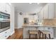 Modern kitchen with granite island, stainless steel appliances, and hardwood floors at 6841 Chapel Glen Ct, Peachtree Corners, GA 30360