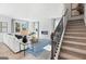 Living room with staircase, fireplace, and seating area at 7071 Brushwood Bend, Lithonia, GA 30058