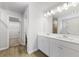 Double vanity bathroom with white cabinets and a walk-in closet at 7065 Brushwood Bnd, Lithonia, GA 30058