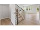 Light-filled entryway with hardwood floors and staircase at 7065 Brushwood Bnd, Lithonia, GA 30058