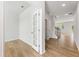 Bright foyer with hardwood floors, leading to living room and staircase at 7065 Brushwood Bnd, Lithonia, GA 30058