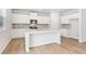 Modern kitchen with white cabinets, granite countertops, and island at 7065 Brushwood Bnd, Lithonia, GA 30058