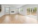 Open concept living room with hardwood floors, fireplace, and access to backyard at 7065 Brushwood Bnd, Lithonia, GA 30058