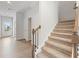 Staircase with carpet runner and metal railing at 7065 Brushwood Bnd, Lithonia, GA 30058
