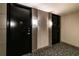 Building hallway with two apartment doors and modern light fixtures at 2626 Peachtree Nw Rd # 412, Atlanta, GA 30305