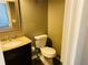 Small bathroom with granite countertop vanity and toilet at 115 Boxford Ct, Johns Creek, GA 30022