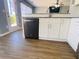 Modern kitchen featuring white shaker cabinets, stainless steel appliances, and wood-look flooring at 115 Boxford Ct, Johns Creek, GA 30022