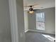 Bedroom featuring a window, ceiling fan, and grey carpet at 1312 Buttercup Ct, Lawrenceville, GA 30044