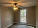 Bright bedroom with neutral walls, carpeting, and ceiling fan at 1312 Buttercup Ct, Lawrenceville, GA 30044