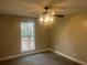 Cozy bedroom with carpet flooring, a ceiling fan, and a large window at 1312 Buttercup Ct, Lawrenceville, GA 30044