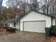 Ranch style home with attached garage and landscaping at 1312 Buttercup Ct, Lawrenceville, GA 30044