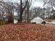 House with a yard covered in autumn leaves at 1312 Buttercup Ct, Lawrenceville, GA 30044