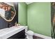 Stylish bathroom with green walls, modern vanity, and gold mirror at 943 Hickory Leaf Se Ct # 1, Marietta, GA 30067