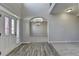 Bright foyer with wood-look flooring and arched entryways leading to adjacent rooms at 4463 Grove Lake St, Loganville, GA 30052