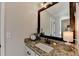 Bathroom with granite countertop and dark frame mirror at 1741 Mulberry Lake Dr, Dacula, GA 30019