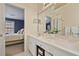Bathroom with double vanity, a view into bedroom, and a window at 260 Wildcat Lake Dr, Lawrenceville, GA 30043