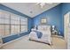 Bright bedroom with blue walls, large window, and carpeted floor at 260 Wildcat Lake Dr, Lawrenceville, GA 30043