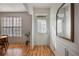 Bright and airy entryway with hardwood floors, a mirror, and a view into the dining area at 260 Wildcat Lake Dr, Lawrenceville, GA 30043