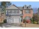 Two-story brick and gray siding house with a two-car garage and manicured lawn at 260 Wildcat Lake Dr, Lawrenceville, GA 30043