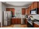 Modern kitchen with stainless steel appliances and wood cabinets at 260 Wildcat Lake Dr, Lawrenceville, GA 30043