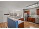 Modern kitchen with stainless steel appliances, wood cabinets, and a breakfast bar at 260 Wildcat Lake Dr, Lawrenceville, GA 30043