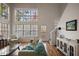 Spacious living room with hardwood floors, large windows, and access to a deck at 260 Wildcat Lake Dr, Lawrenceville, GA 30043