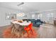 Dining area with oval table, vibrant chairs, and a modern light fixture at 691 Cordele Ln, Sugar Hill, GA 30518
