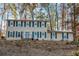 Two-story house with stone retaining wall and landscaping, nestled among trees at 5440 Tally Green Dr, Marietta, GA 30068