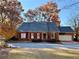 Brick home with gray roof, red shutters, and attached garage at 15 Downshire Ln, Decatur, GA 30033