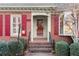 Red front door with red shutters, brick steps, and a lamp post at 15 Downshire Ln, Decatur, GA 30033