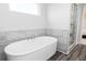 Relaxing bathroom featuring a large soaking tub and gray tile at 406 Newland Way, Acworth, GA 30102