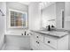 Bathroom with granite countertop, white cabinets, and a soaking tub at 739 Reeves Lake Sw Dr, Marietta, GA 30064