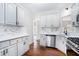 Modern kitchen with white cabinets, marble backsplash, stainless steel appliances, and hardwood floors at 739 Reeves Lake Sw Dr, Marietta, GA 30064