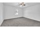 Well-lit bedroom with grey carpet and a ceiling fan at 3070 Branford Ct, Marietta, GA 30062