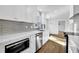 Modern kitchen featuring white cabinets, quartz countertops, and stainless steel appliances at 3070 Branford Ct, Marietta, GA 30062