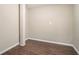 Empty basement room with dark brown tile floor and neutral walls at 2991 The Meadows Way, Atlanta, GA 30349