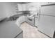 Kitchen with white cabinets, gray countertops, and gas range at 4279 Orchard Grv, Stone Mountain, GA 30083