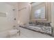 Updated bathroom with white subway tile and granite vanity at 2326 Chestnut Log Dr, Lithia Springs, GA 30122