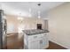 Granite kitchen island with white cabinets and modern lighting at 2326 Chestnut Log Dr, Lithia Springs, GA 30122
