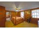 Bedroom featuring wood paneling, ceiling fan, and a view into another room at 2948 Lenora Rd, Snellville, GA 30039
